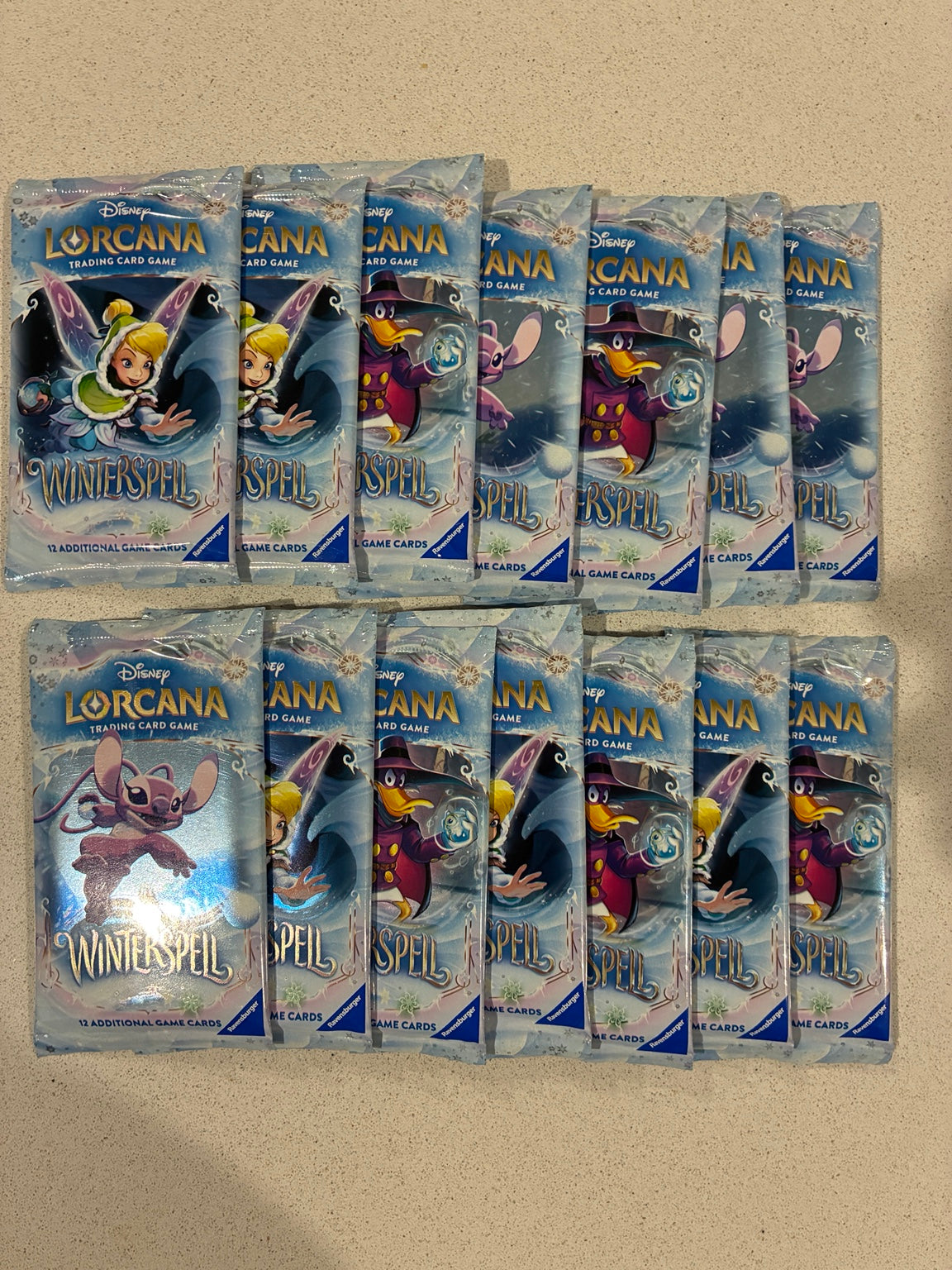 Fourteen sealed Disney Lorcana Winterspell booster packs