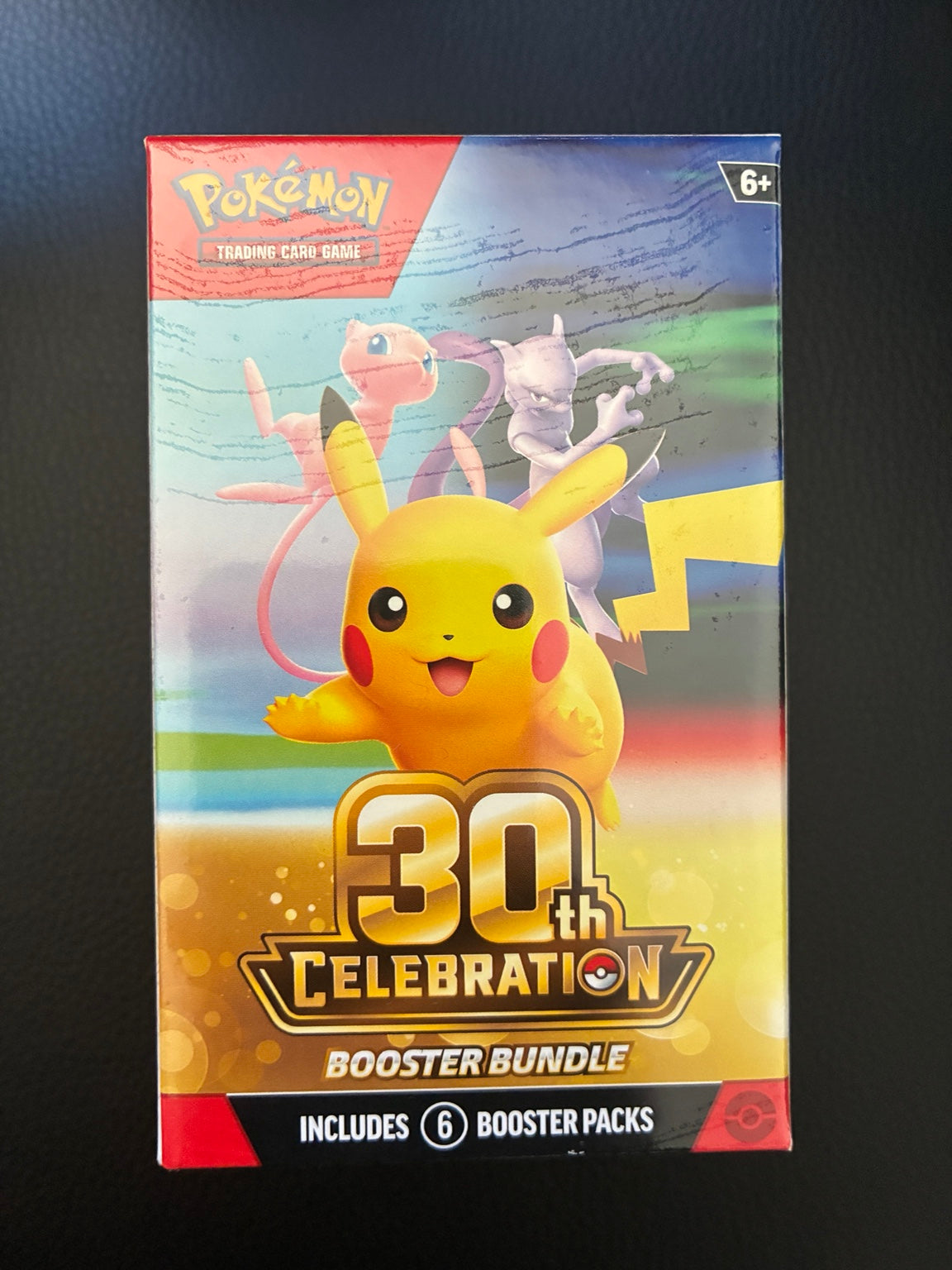 Actual English Pokémon TCG 30th Celebration Booster Bundle packaging featuring Pikachu, Mew and Mewtwo, labelled as containing six booster packs.
