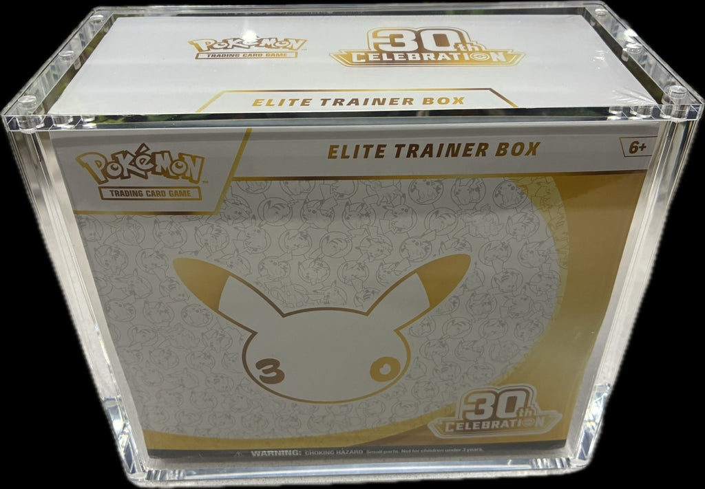 Angled front and top view of the Pokémon 30th Celebration Elite Trainer Box in its acrylic display case